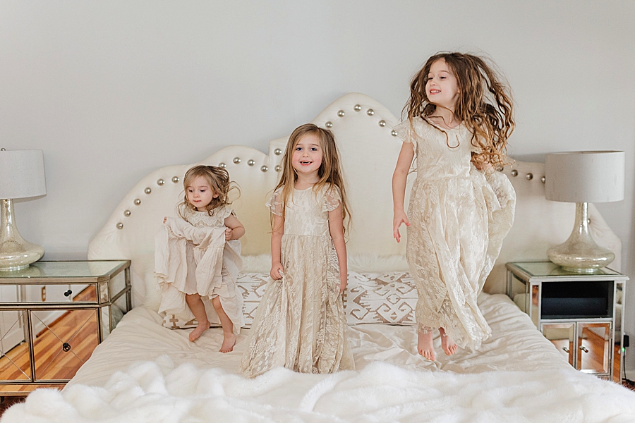 Girls jumping on the bed 12 month lifestyle session