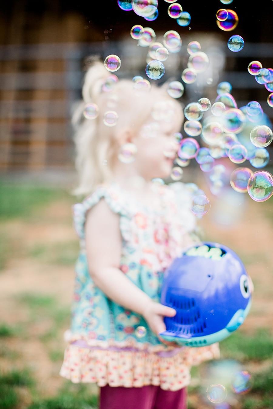 2 years old holding bubble machine