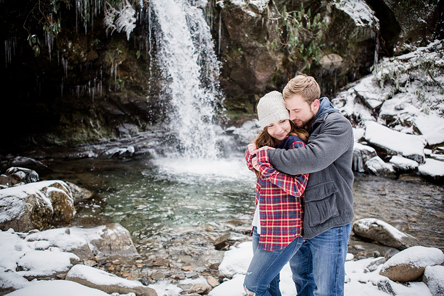 Standing in front of a waterfall engagement photo by Knoxville Wedding Photographer, Amanda May Photos.