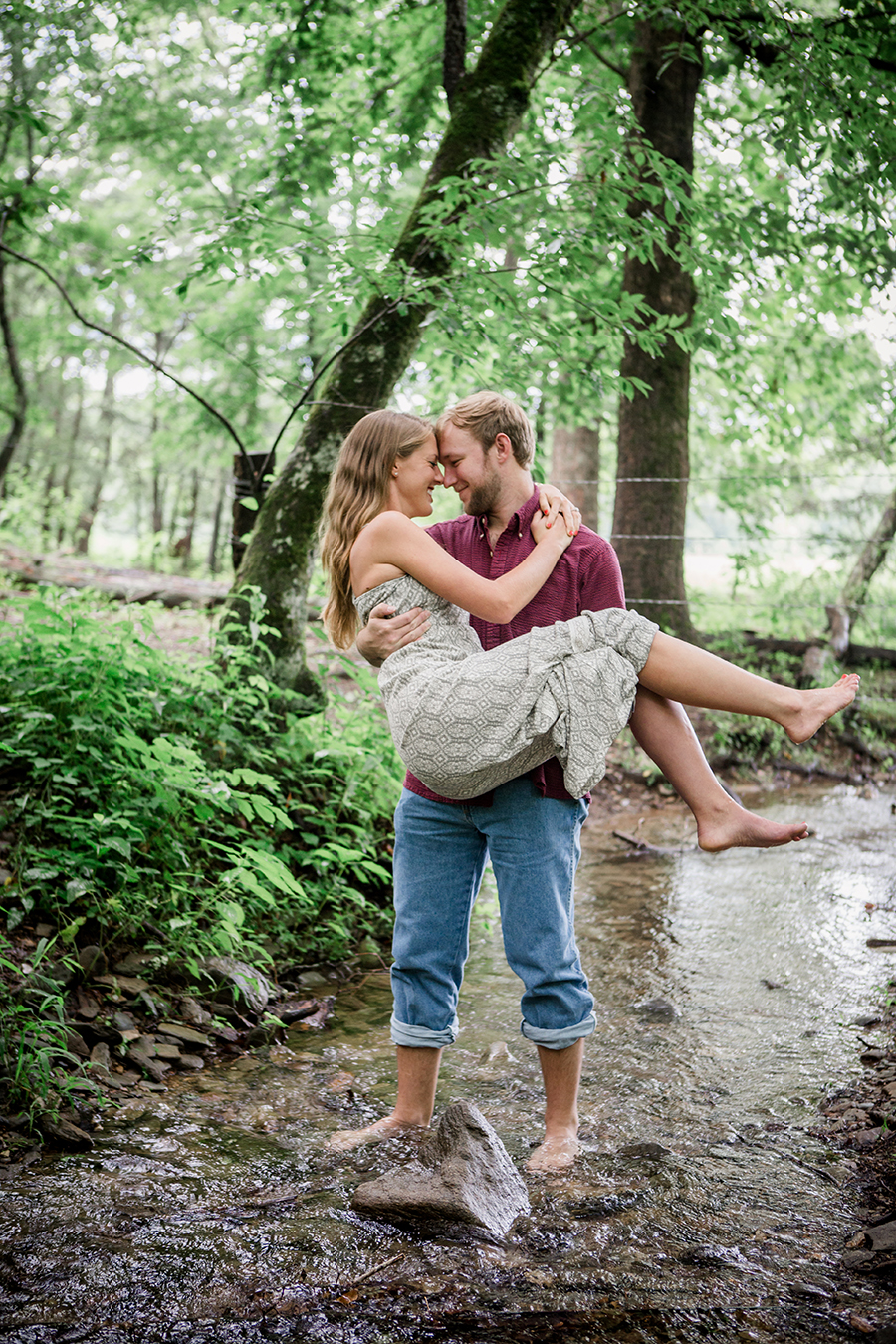 He cradles her engagement photo by Knoxville Wedding Photographer, Amanda May Photos.