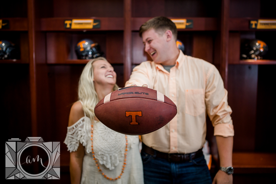 Football in the forefront engagement photo by Knoxville Wedding Photographer, Amanda May Photos.