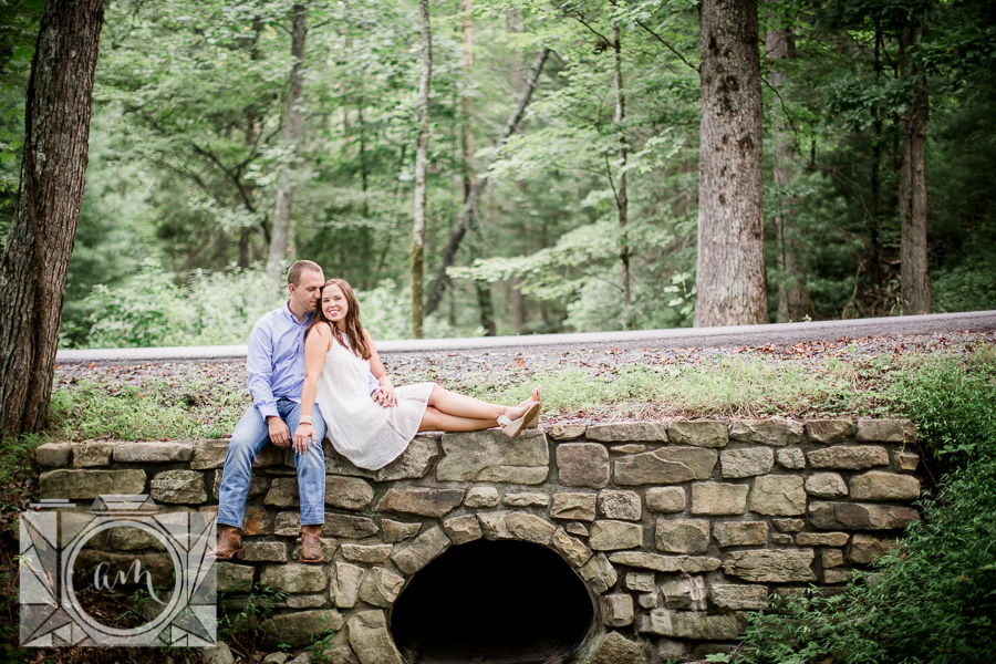 Sitting on stone wall engagement photo by Knoxville Wedding Photographer, Amanda May Photos.