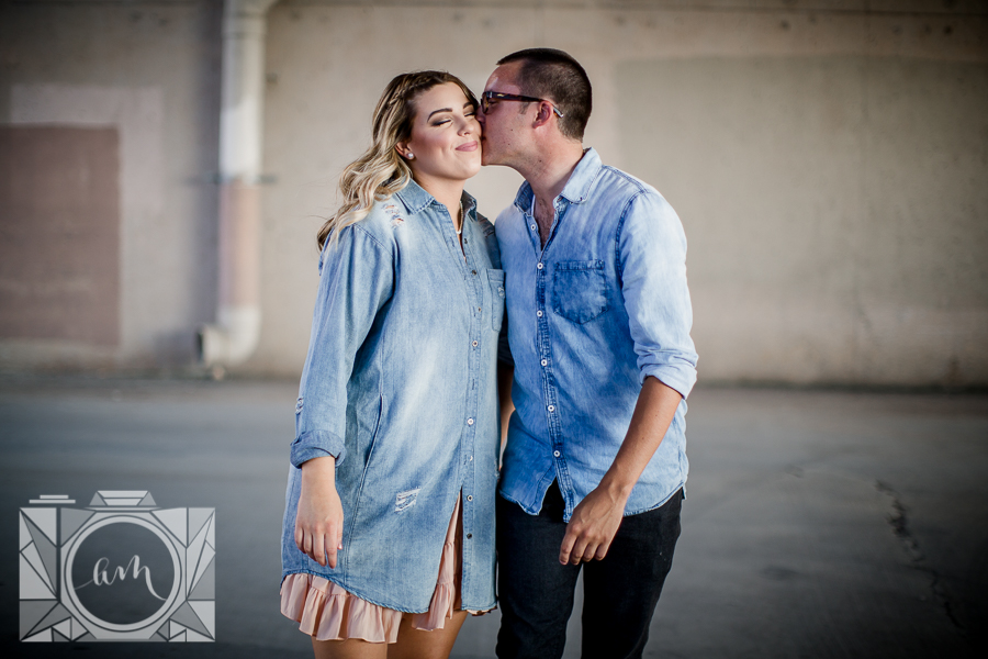 Walking and kissing her cheek engagement photo by Knoxville Wedding Photographer, Amanda May Photos.