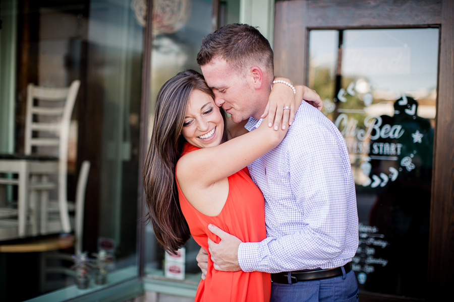 Her arms around his neck engagement photo by Knoxville Wedding Photographer, Amanda May Photos.