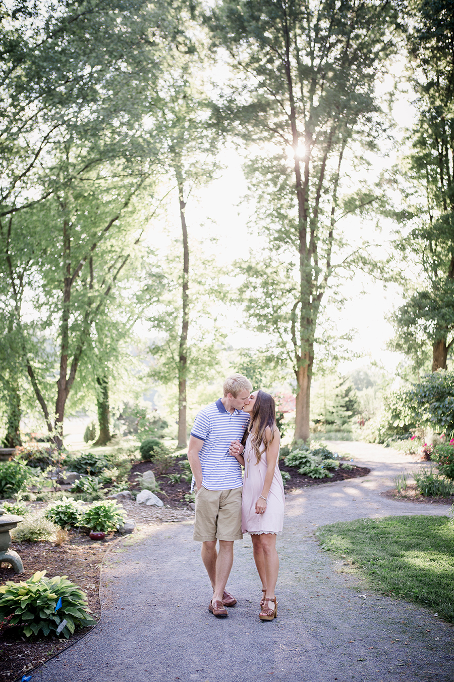 Walking and kissing engagement photo by Knoxville Wedding Photographer, Amanda May Photos.