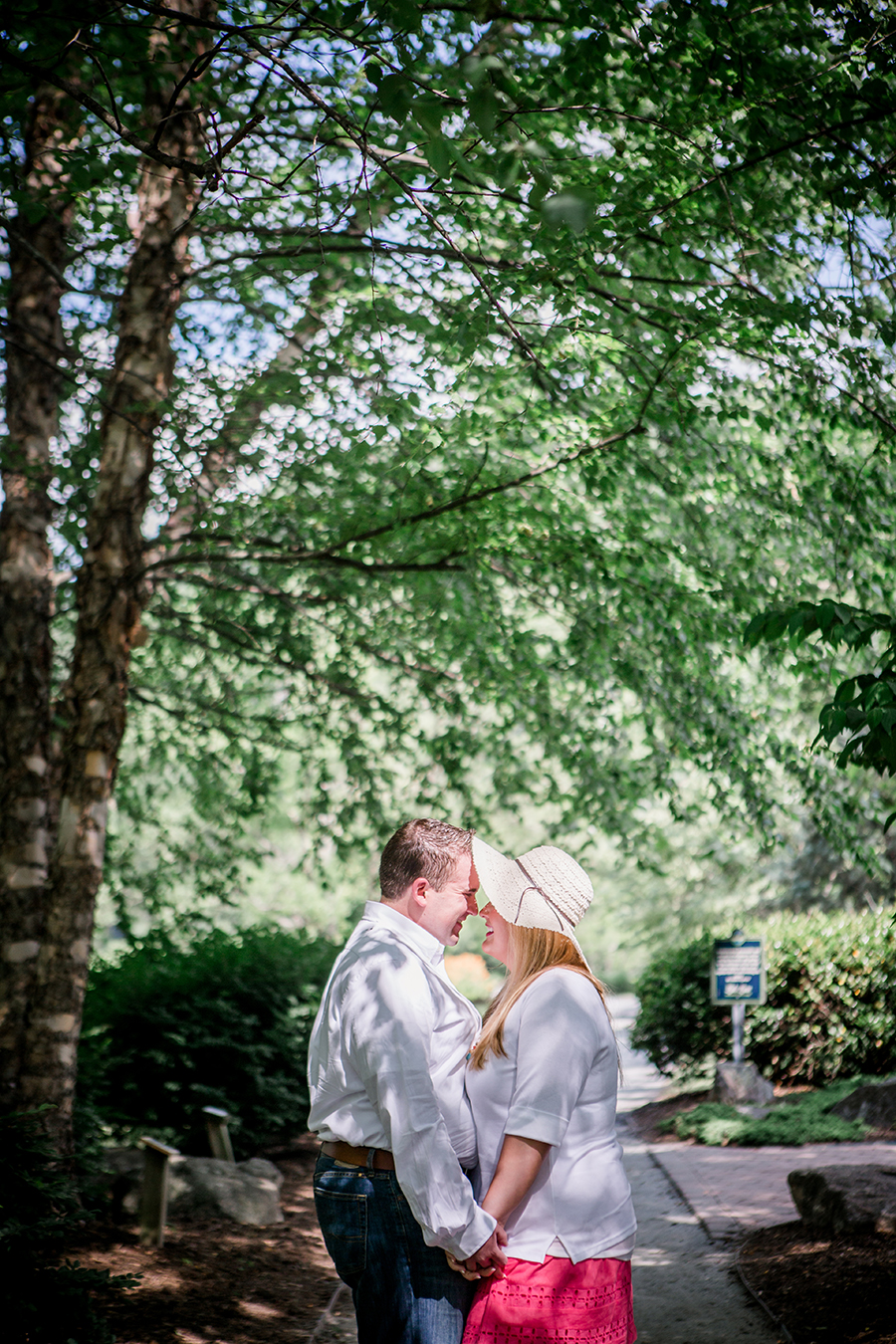 Snuggles under a shaded tree engagement photo by Knoxville Wedding Photographer, Amanda May Photos.