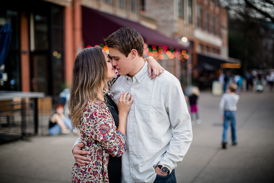 Her arm around his neck kissing engagement photo by Knoxville Wedding Photographer, Amanda May Photos.