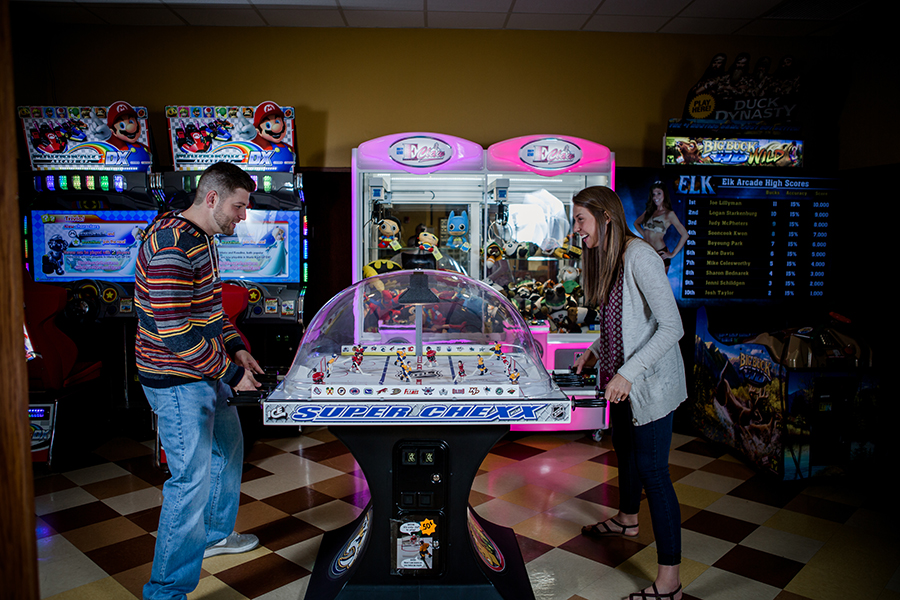 Playing some arcade games engagement photo by Knoxville Wedding Photographer, Amanda May Photos.