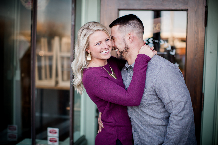 Laughing together with her hands around his neck engagement photo by Knoxville Wedding Photographer, Amanda May Photos.