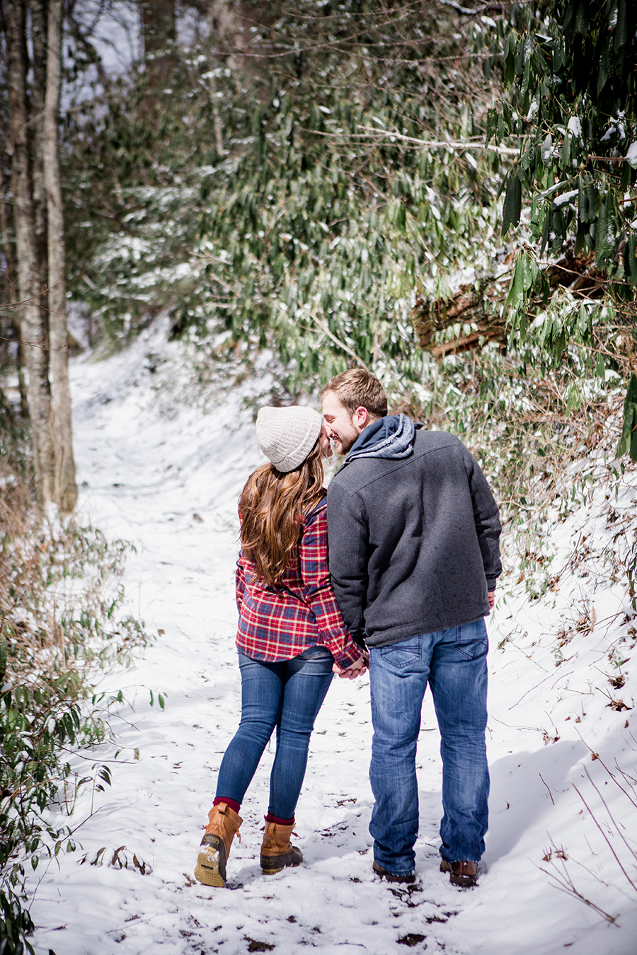 Kissing over their shoulders engagement photo by Knoxville Wedding Photographer, Amanda May Photos.