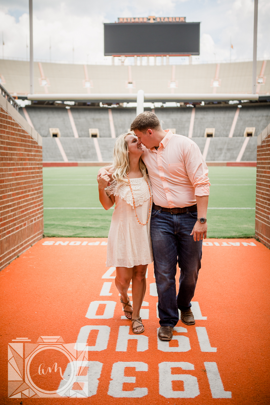 Walking in the stadium engagement photo by Knoxville Wedding Photographer, Amanda May Photos.