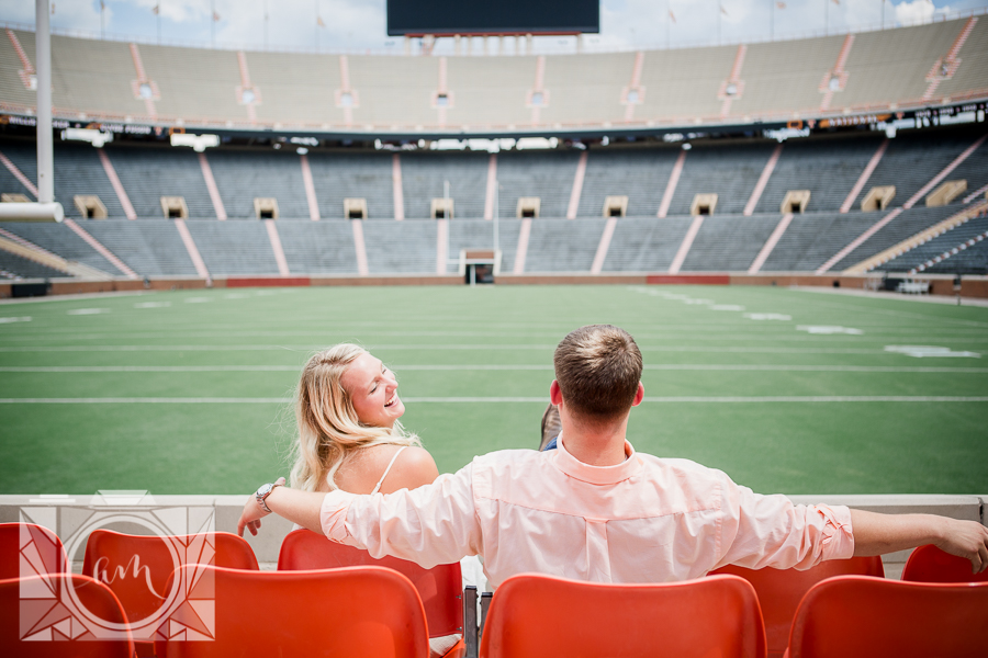 His arms around her in Neyland stadium engagement photo by Knoxville Wedding Photographer, Amanda May Photos.