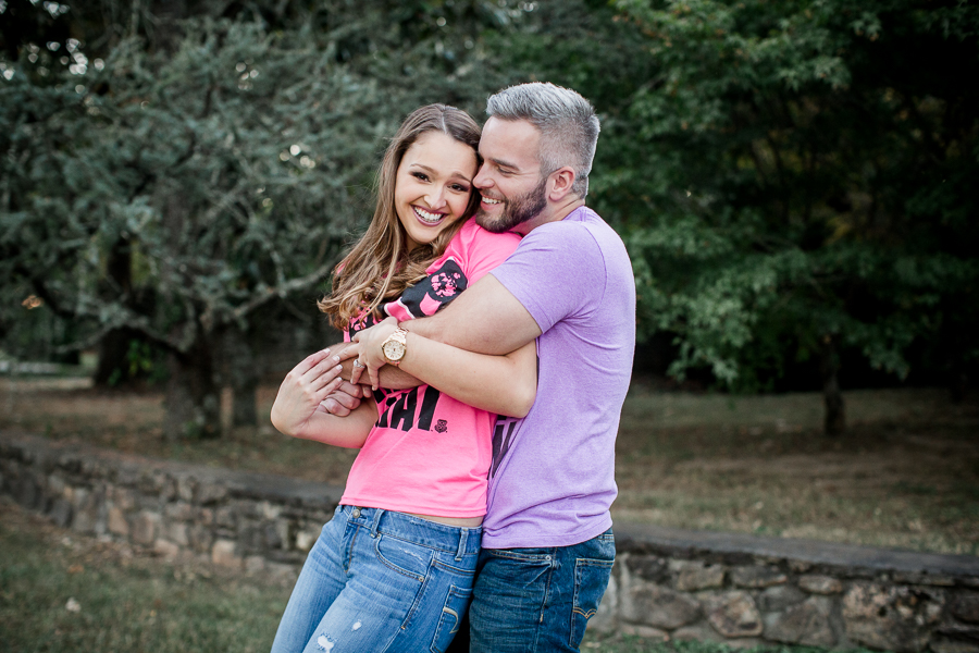 Squeezing her from behind engagement photo by Knoxville Wedding Photographer, Amanda May Photos.