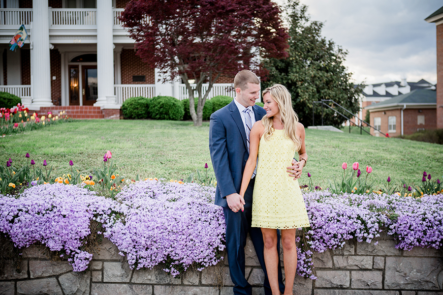 Standing in front of weeping flowers engagement photo by Knoxville Wedding Photographer, Amanda May Photos.