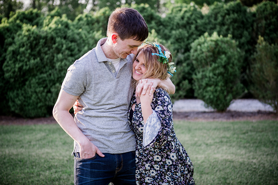 Pulling her shoulders towards him engagement photo by Knoxville Wedding Photographer, Amanda May Photos.