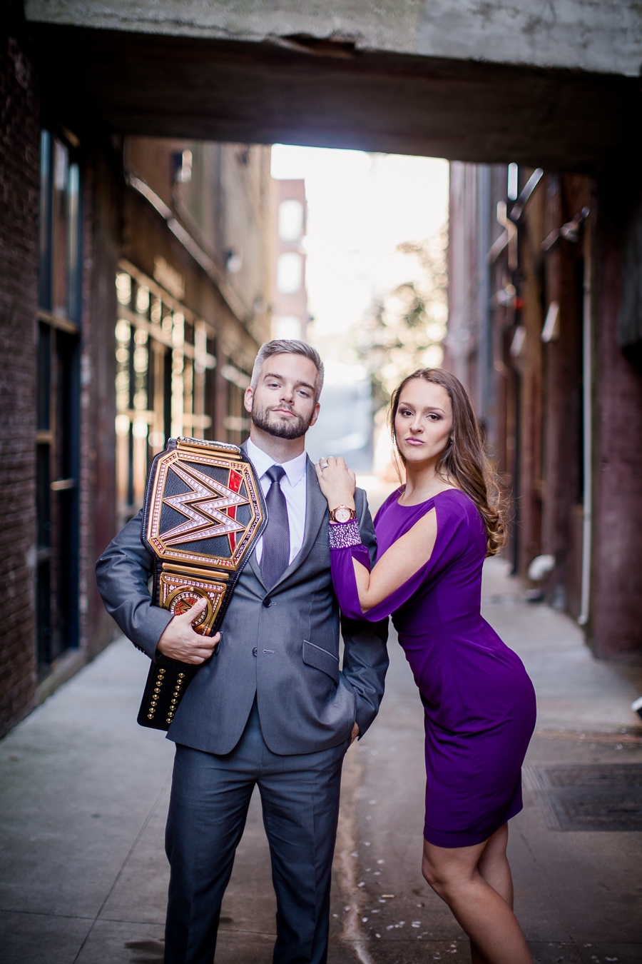 WWE belt on his shoulder engagement photo by Knoxville Wedding Photographer, Amanda May Photos.
