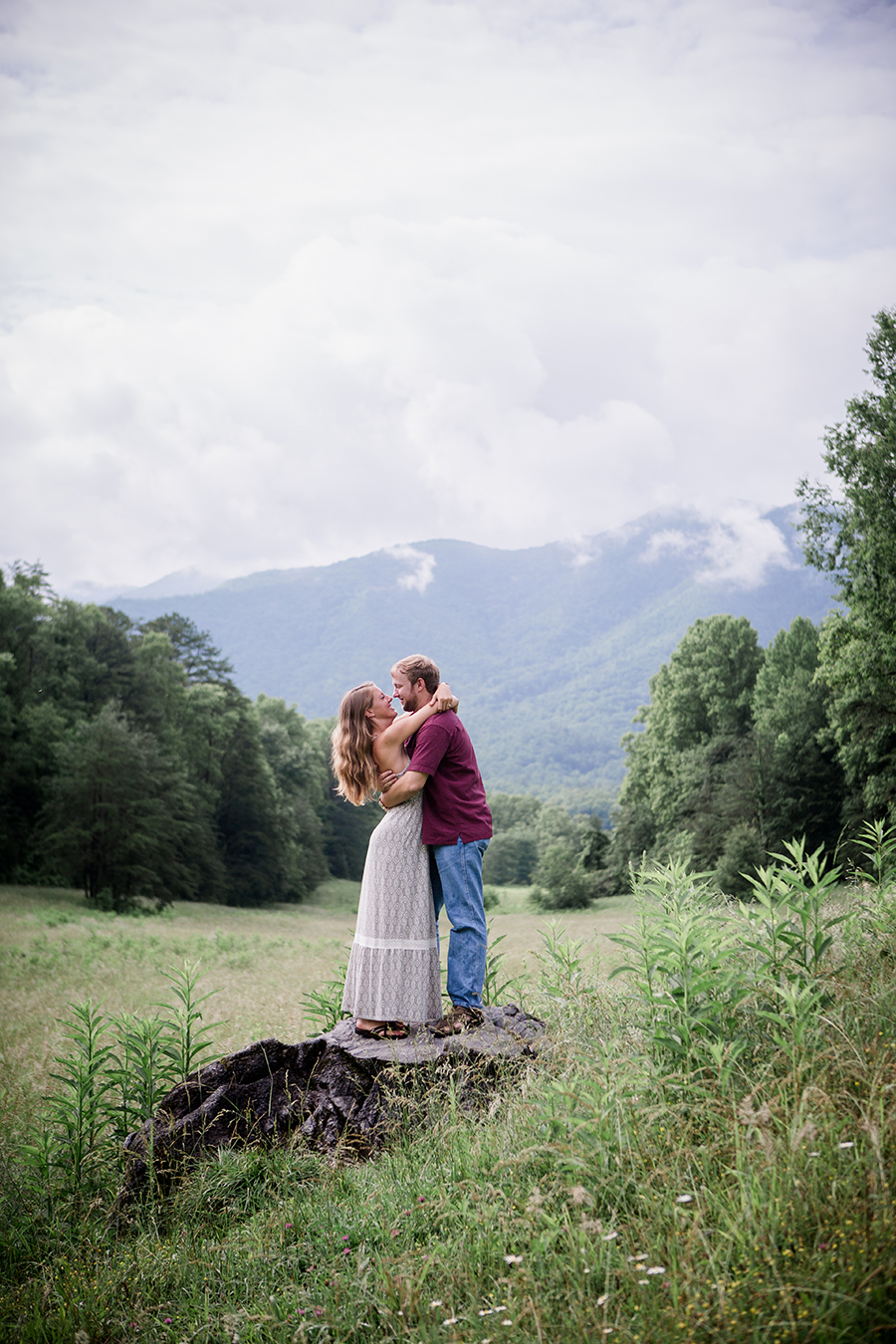 Standing on rock with smokies in the background engagement photo by Knoxville Wedding Photographer, Amanda May Photos.