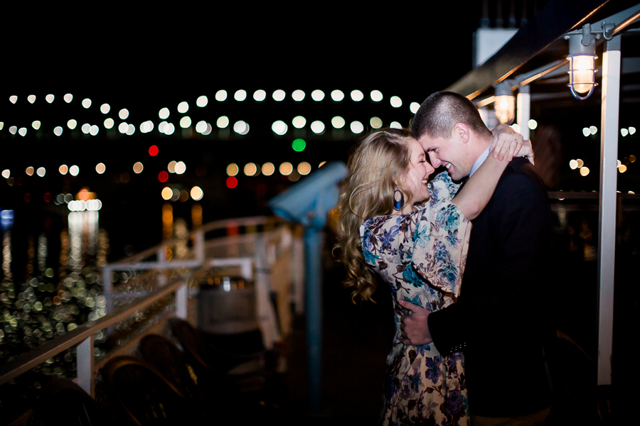Night shot with lights in the background engagement photo by Knoxville Wedding Photographer, Amanda May Photos.