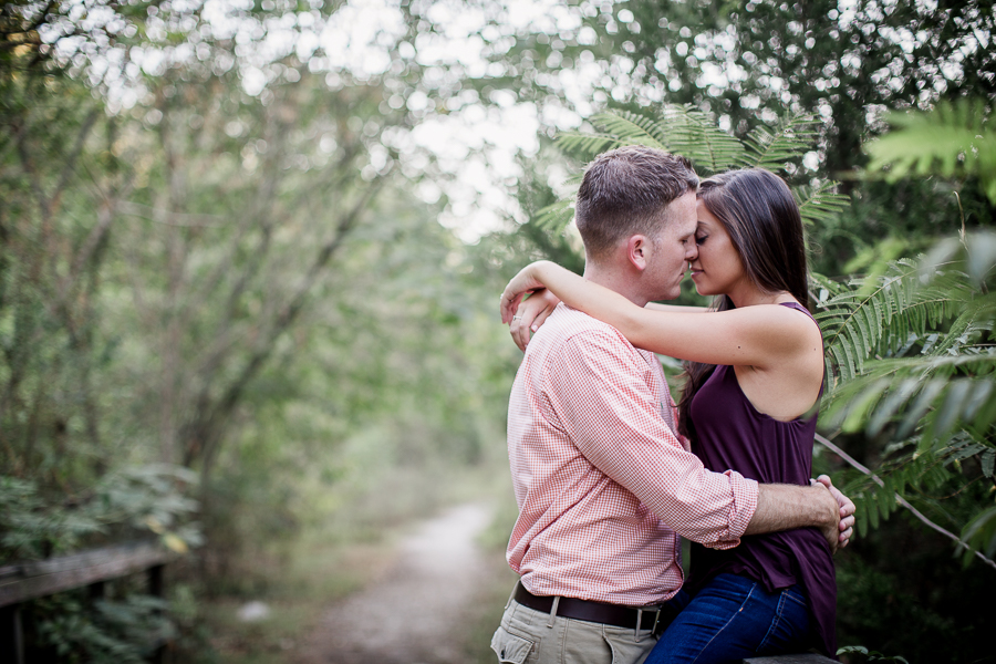 Her arms over his shoulders engagement photo by Knoxville Wedding Photographer, Amanda May Photos.