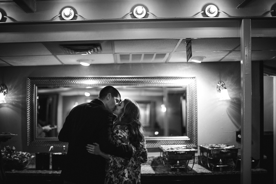 Kissing in front of the buffet engagement photo by Knoxville Wedding Photographer, Amanda May Photos.