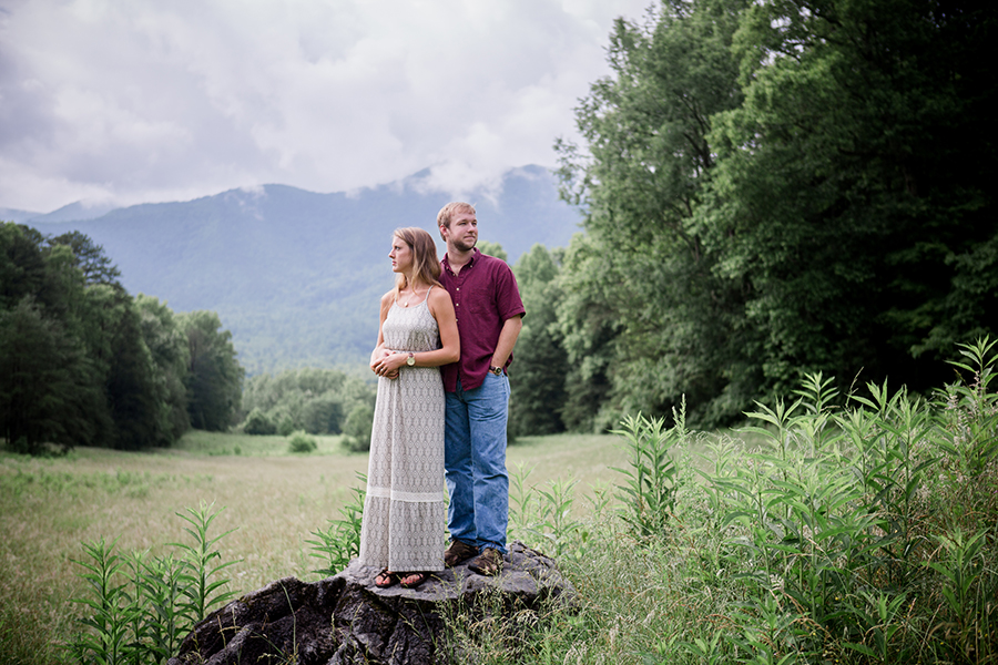 Standing on rock looking opposite directions engagement photo by Knoxville Wedding Photographer, Amanda May Photos.
