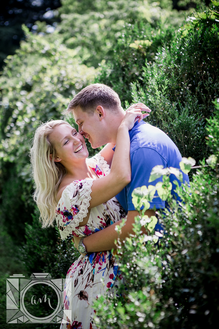 Her hands around his neck laughing engagement photo by Knoxville Wedding Photographer, Amanda May Photos.
