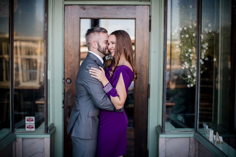 Standing in front of restaurant engagement photo by Knoxville Wedding Photographer, Amanda May Photos.