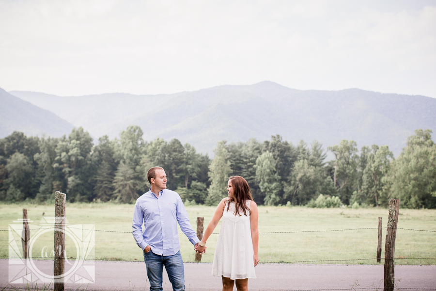 Holding hands parallel in front of smoky mountains engagement photo by Knoxville Wedding Photographer, Amanda May Photos.