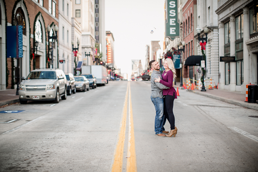 Laughing in the middle of the street engagement photo by Knoxville Wedding Photographer, Amanda May Photos.