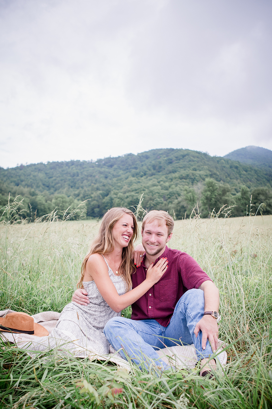 Sitting on a blanket laughing engagement photo by Knoxville Wedding Photographer, Amanda May Photos.