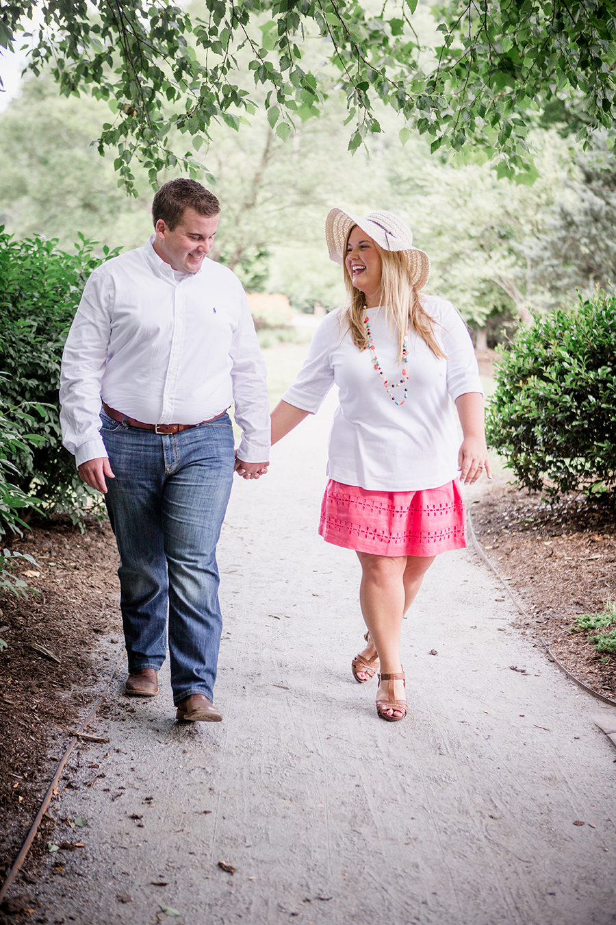 Walking in her floppy hat engagement photo by Knoxville Wedding Photographer, Amanda May Photos.