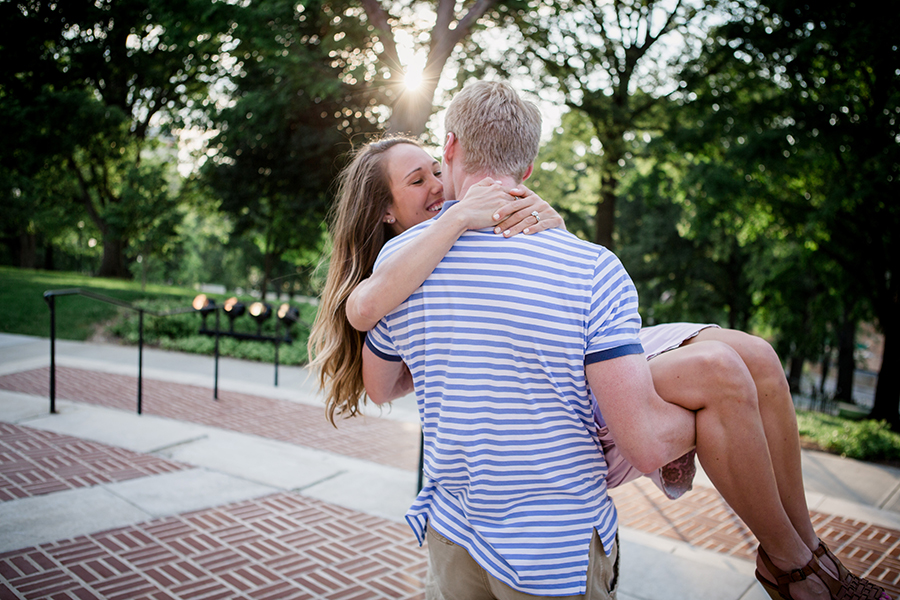 Cradling her in the sunlight engagement photo by Knoxville Wedding Photographer, Amanda May Photos.