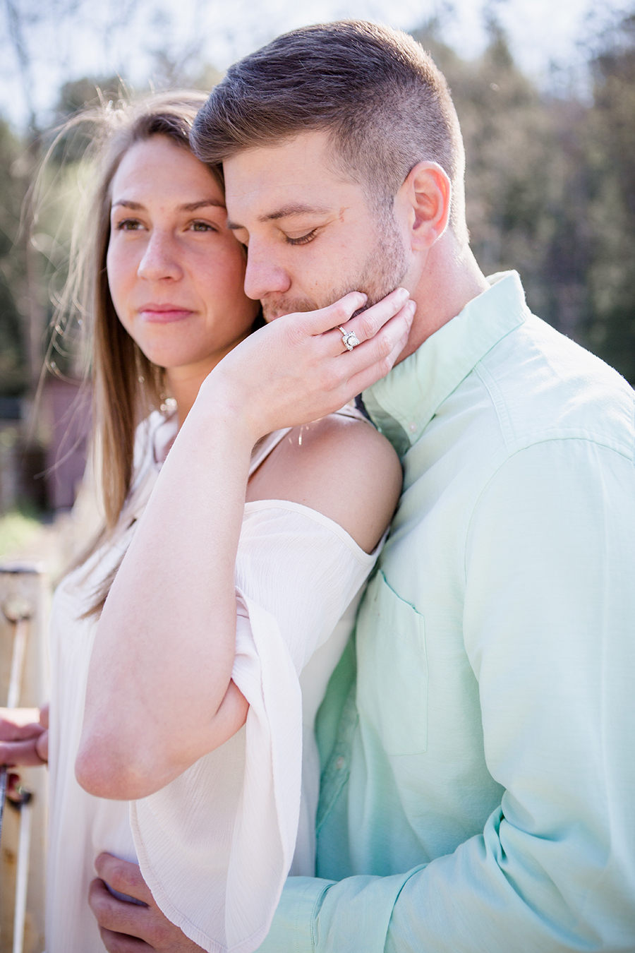 Her left hand reaching back to his cheek engagement photo by Knoxville Wedding Photographer, Amanda May Photos.