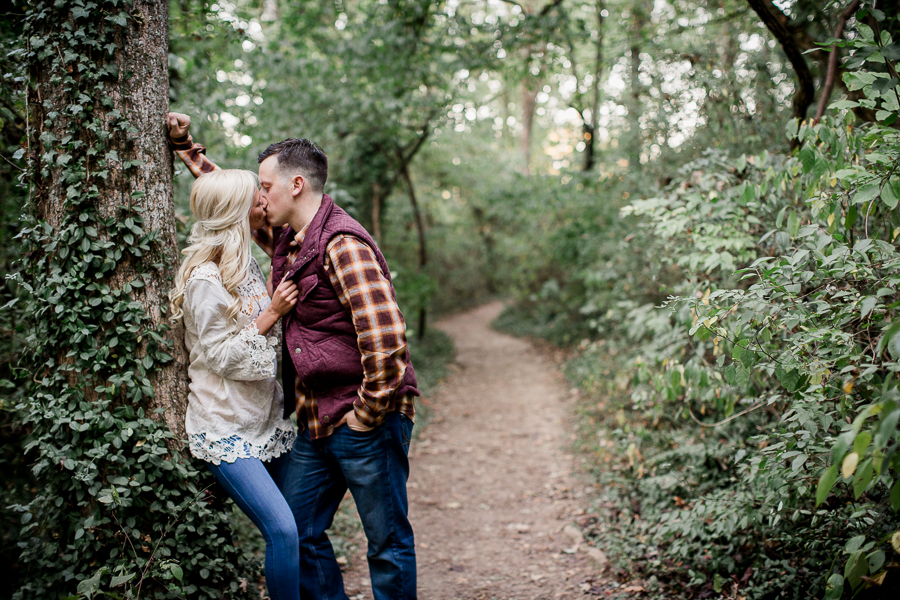 She leans against tree engagement photo by Knoxville Wedding Photographer, Amanda May Photos.