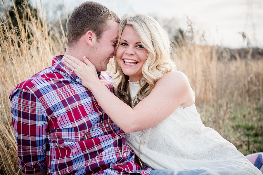 She leans into him and laughs engagement photo by Knoxville Wedding Photographer, Amanda May Photos.