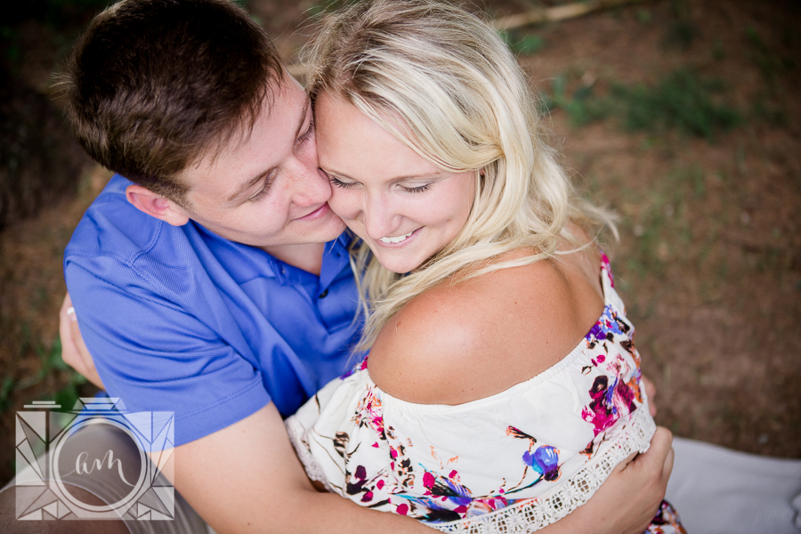He cuddles her cheek engagement photo by Knoxville Wedding Photographer, Amanda May Photos.