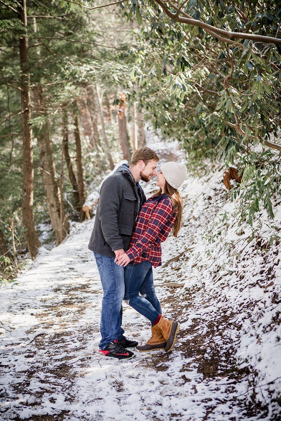Standing on snowy trail engagement photo by Knoxville Wedding Photographer, Amanda May Photos.
