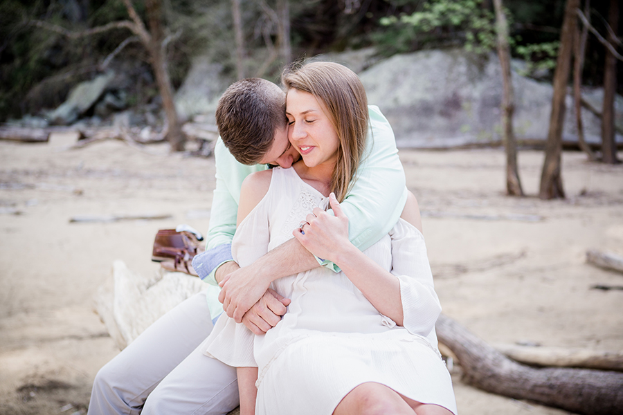 She leans into his hug engagement photo by Knoxville Wedding Photographer, Amanda May Photos.