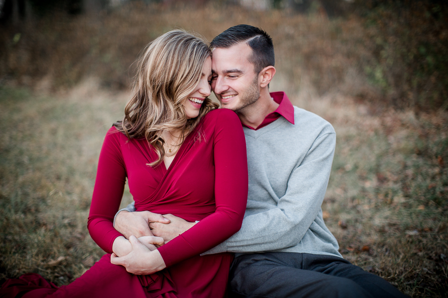 Maroon snuggles in the leaves engagement photo by Knoxville Wedding Photographer, Amanda May Photos.