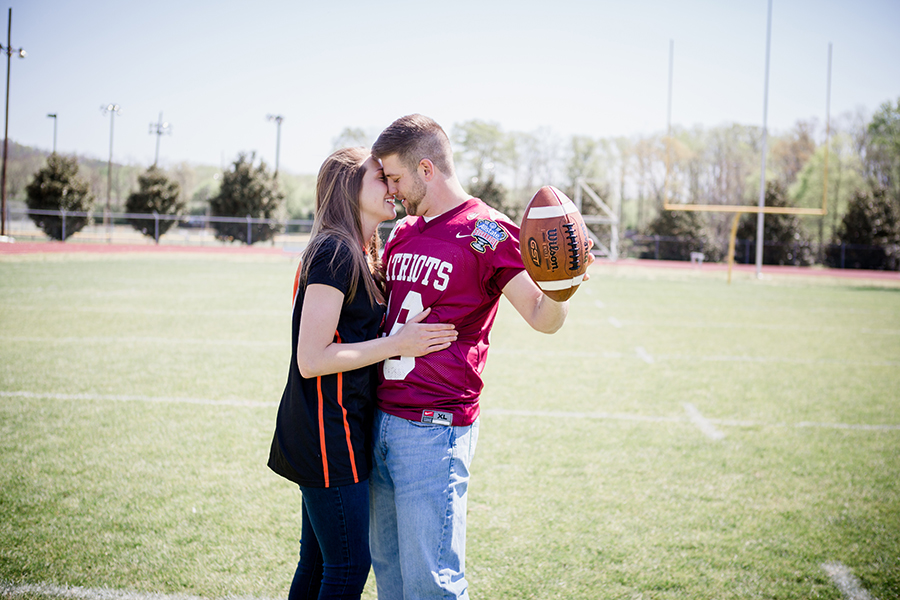 On the football field engagement photo by Knoxville Wedding Photographer, Amanda May Photos.
