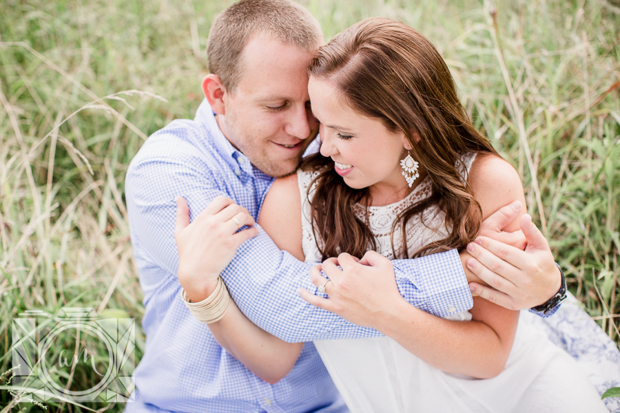 Looking down on her in the grass engagement photo by Knoxville Wedding Photographer, Amanda May Photos.