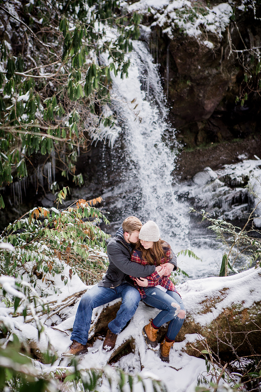 Sitting in front of a waterfall engagement photo by Knoxville Wedding Photographer, Amanda May Photos.