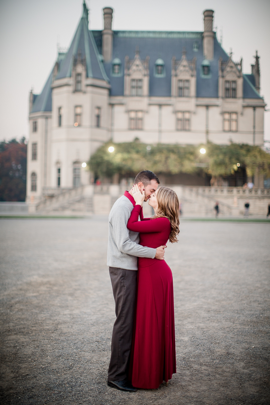 Kissing in front Biltmore engagement photo by Knoxville Wedding Photographer, Amanda May Photos.