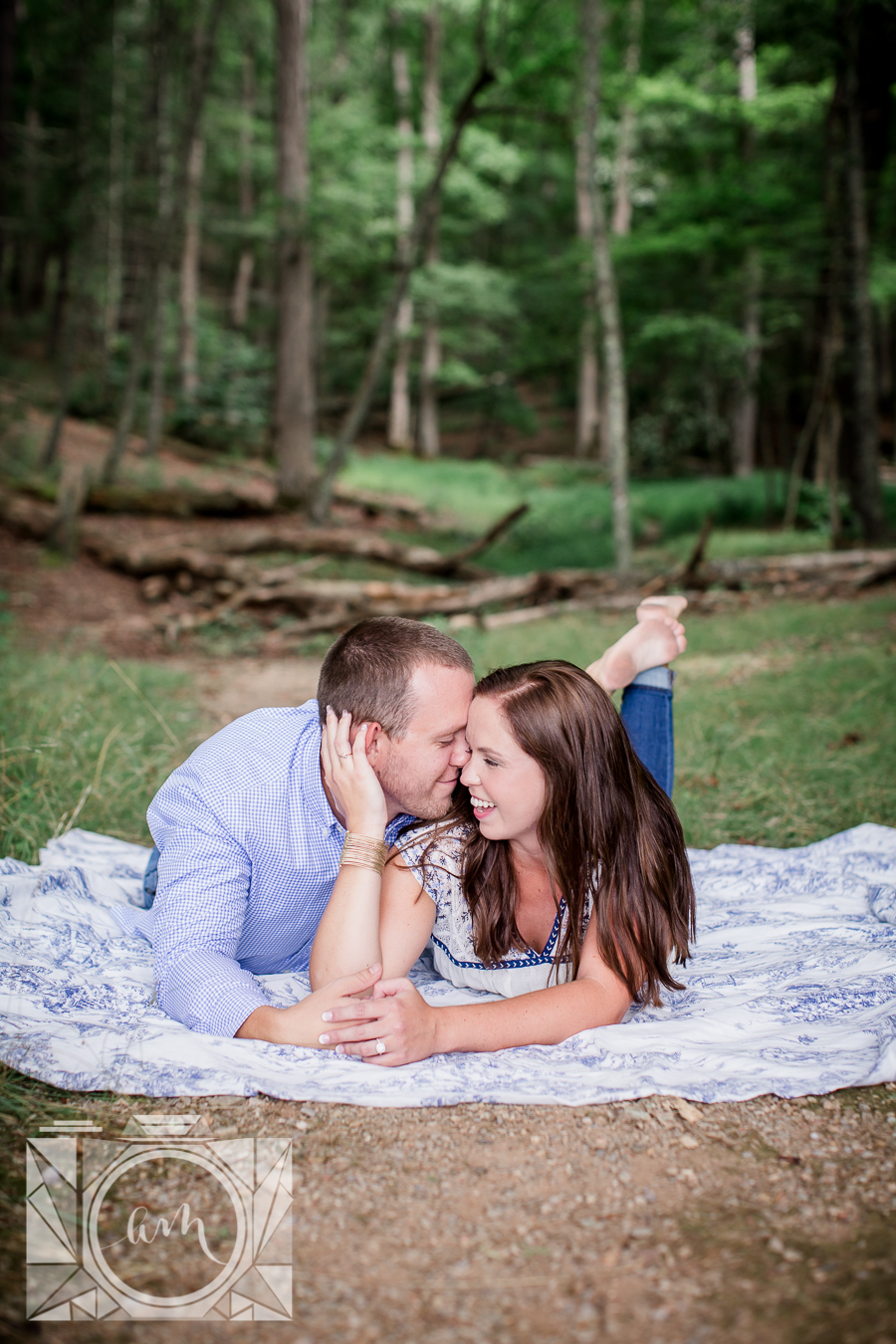 Laying on their stomachs engagement photo by Knoxville Wedding Photographer, Amanda May Photos.