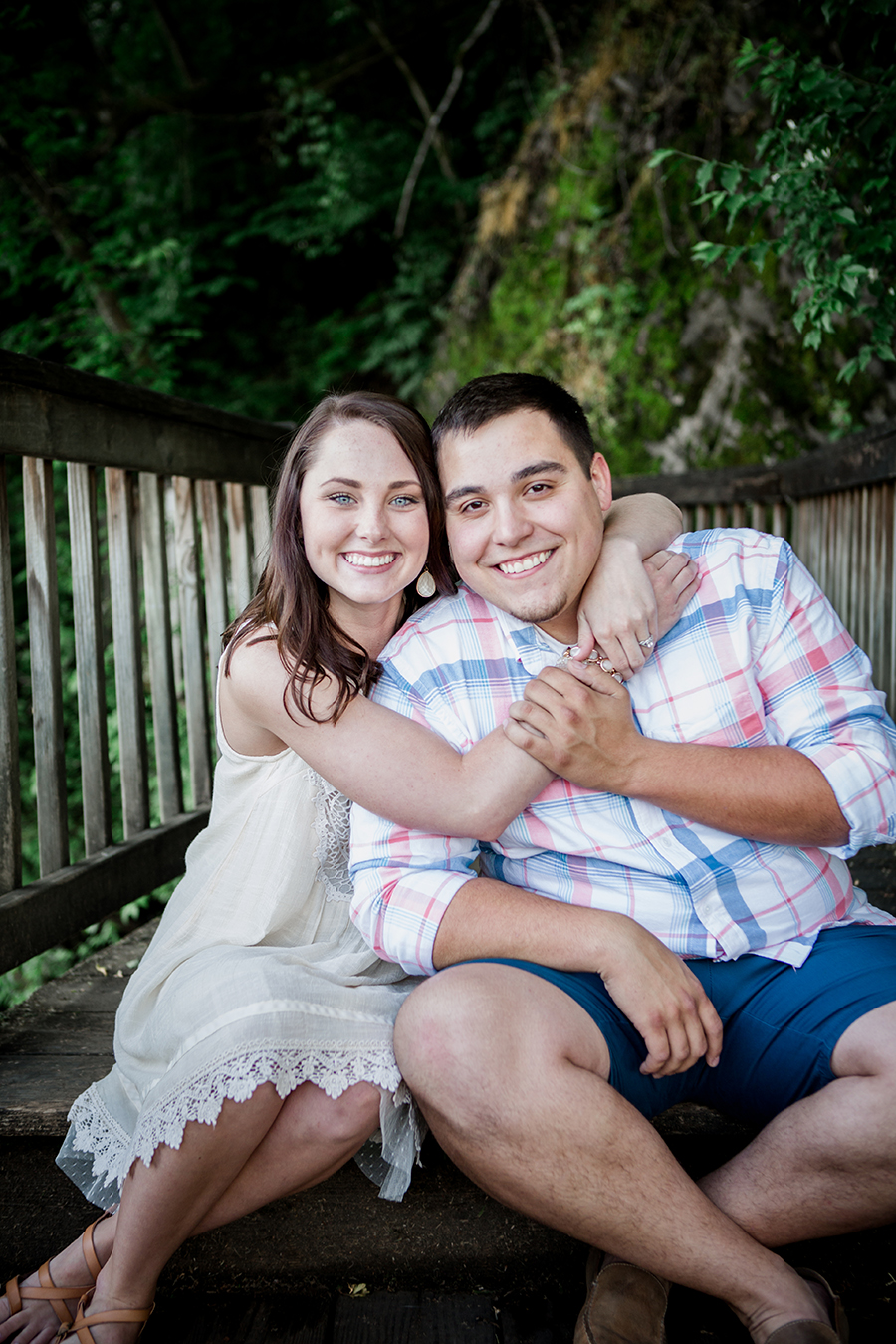 Her arms around his neck sitting down engagement photo by Knoxville Wedding Photographer, Amanda May Photos.