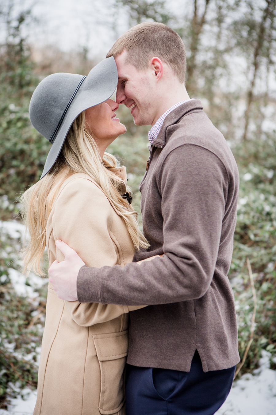 Floppy hat kiss engagement photo by Knoxville Wedding Photographer, Amanda May Photos.