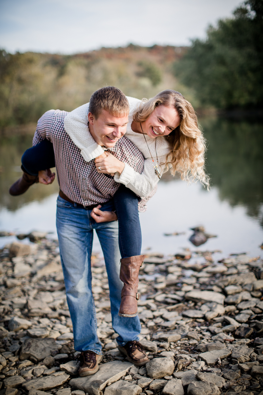 Playing with her on his back engagement photo by Knoxville Wedding Photographer, Amanda May Photos.