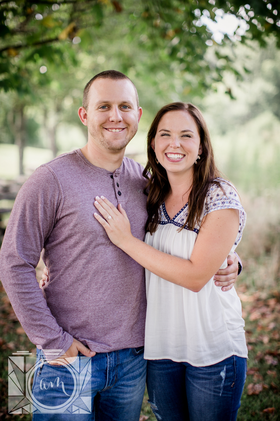 Her hand on his chest looking at camera engagement photo by Knoxville Wedding Photographer, Amanda May Photos.