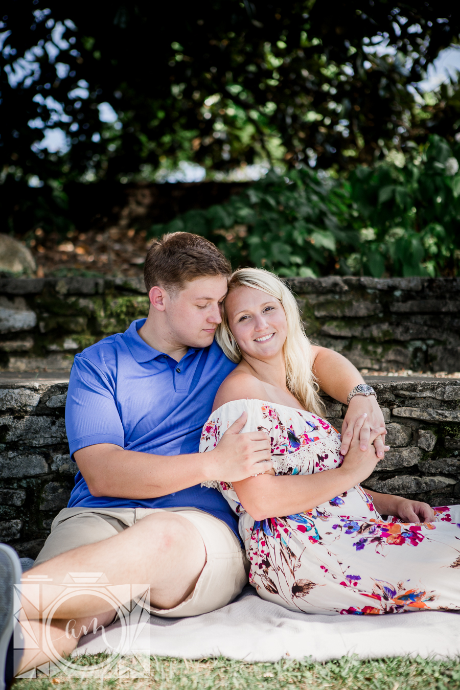 Her back against his chest sitting engagement photo by Knoxville Wedding Photographer, Amanda May Photos.