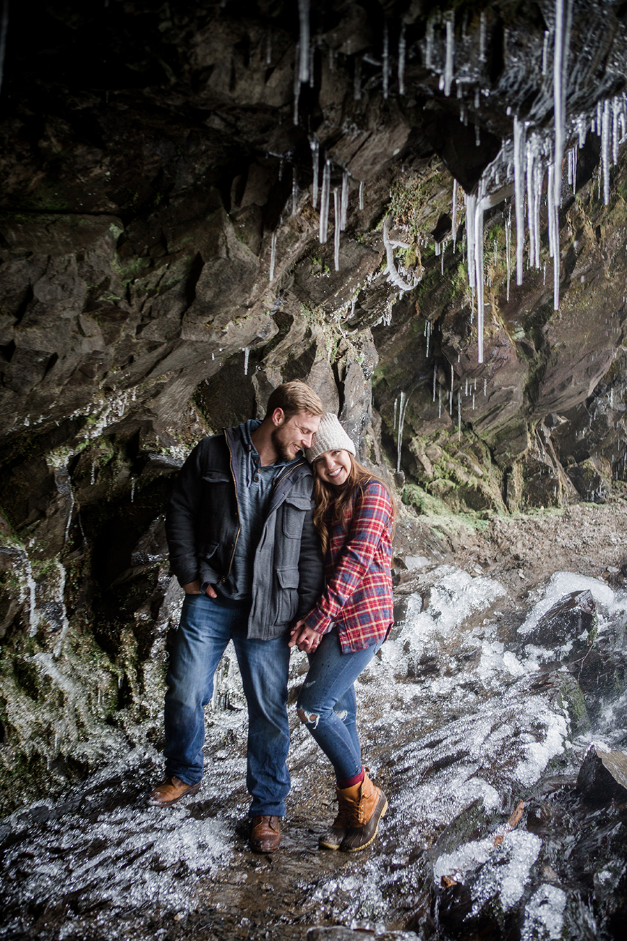 Standing under the icecycles engagement photo by Knoxville Wedding Photographer, Amanda May Photos.